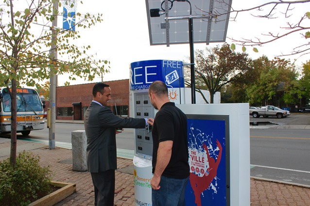 Mayor Curtatone is given a demonstration of the Solar Z cell phone charging locker