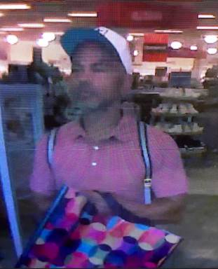 Robbery suspect: a white (tanned) male or light skinned Hispanic male with facial hair wearing a pink polo shirt, blue jeans, sunglasses, a white baseball cap, and sunglasses