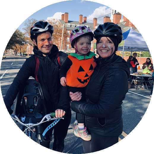 Family wearing bike helmets and Halloween costumes