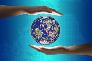 Artistic photo of two hands surrounding a globe